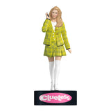 Figurine of a character in a yellow plaid outfit with 'Clueless' branding on a white background. Celebrate the holidays with the Clueless Cher Horowitz Ornament! Press for iconic quotes and add a touch of '90s nostalgia to your tree.