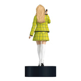 Figurine of a person in a yellow plaid outfit on a white background Celebrate the holidays with the Clueless Cher Horowitz Ornament! Press for iconic quotes and add a touch of '90s nostalgia to your tree.