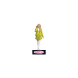 Figurine of a person in a yellow plaid outfit with a visible brand logo on a white background Celebrate the holidays with the Clueless Cher Horowitz Ornament! Press for iconic quotes and add a touch of '90s nostalgia to your tree.