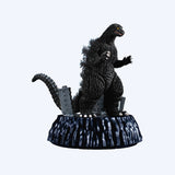  Godzilla figurine standing on a base with buildings in the background. New arrival Godzilla blind box figures Academy Museum