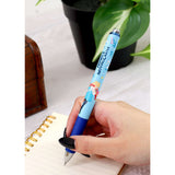 Hand holding a blue pen with cartoon characters, placed on a notebook with a plant in the background. Studio Ghibli Howl’s Moving Castle Ballpoint Pen (Howls; Sophie’s Sky Walk)