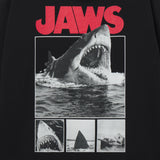 T-shirt with 'JAWS' graphic featuring a shark and movie scenes on a black background.