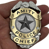 Amity Police Chief badge held in a hand from the movie JAWS (1975) for the 50th Anniversary of the film this is a limited edition officially licensed prop replica