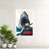 Poster of a shark attacking a boat with 'JAWS' text, placed on a wall with plants below.