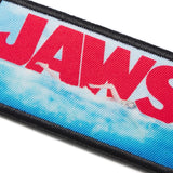Fabric patch with 'JAWS' text and wave design on a white background