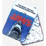 Jaws-themed candy container with shark design and text on a white background Get ready for a sweet adventure with JAWS Amity Island Sours! Enjoy sour shark tooth candies in a collectible tin that celebrates the iconic Jaws movie.