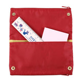 Red pouch with gold zipper and trim, containing a ruler and paper on a white background. Embrace the magic of Studio Ghibli with Kiki's Delivery Service Pen Case! Adorable design, ample storage, and a touch of whimsy for your essentials.