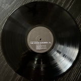 Vinyl record with 'The Virgin Suicides' on a wooden surface
