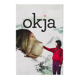 Poster of 'okja' with a person and a creature against a mountainous background