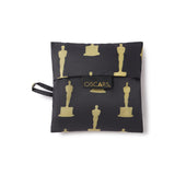 Folded in to a square pouch with Oscars logo tag