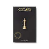 front view of the gold oscar statuette lapel pin on the black and gold logo card