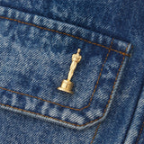 close up view of the gold oscar lapel pin on a denim jacket