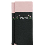 Black knee-high socks with pink accents and floral design on a white background