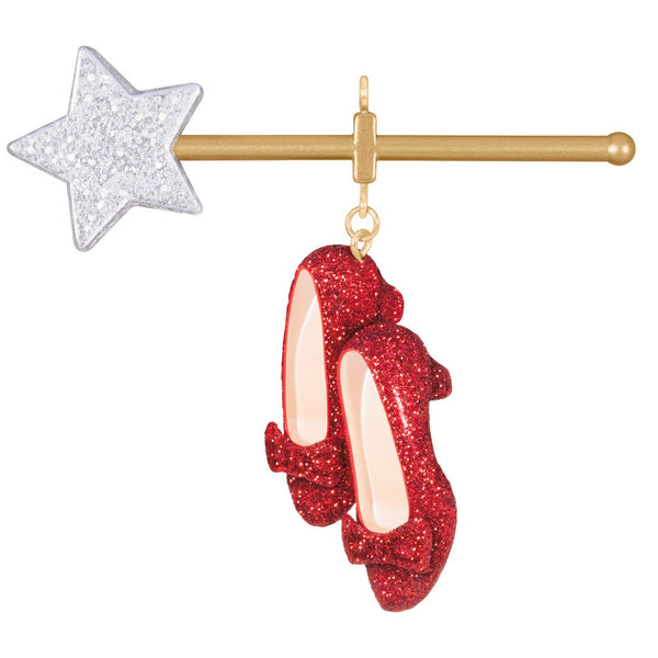 Red glittery shoes ornament with a gold bar and silver star on a white background