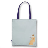 Light blue tote bag with a design of a woman in a dress and the word 'Courage' on a white background