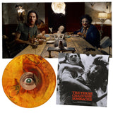 Collage of a group of people around a table with a Halloween-themed decoration, a vinyl record with an eye design, and a movie poster for 'The Texas Chain Saw Massacre'.