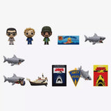 Collection of Jaws-themed figurines and memorabilia on a white background