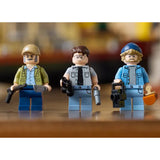 Three LEGO figures with weapons on a wooden surface Jaws (1975) 50th Anniversary Lego Set