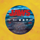 Vinyl record label for 'Jaws' with red text on a blue circle against a yellow background