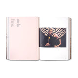 Open book showing a photograph of two people against a patterned background
