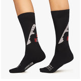 Black socks with guitar pick and text design on a white background