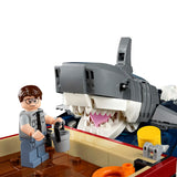 LEGO shark model with a person figure interacting with it on a white  Jaws (1975) 50th Anniversary Lego Setbackground