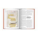 Open book with handwritten notes and highlighted text on a white background