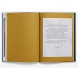 Open book with yellow pages and white text on a white background