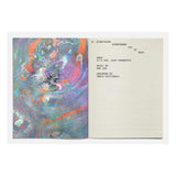 Open book with abstract colorful design on one page and text on the other, on a white background.