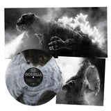 Vinyl record with Godzilla design and text, surrounded by black and white images of Godzilla.