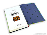 Book with 'Kiki's Delivery Service' cover and blue back featuring black cat illustrations.