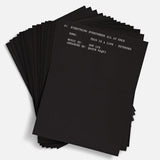 Stack of black sheets with white text on a white background