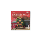 Book cover of 'Spirited Away' with a traditional Japanese building illustration on a red background  the bathhouse from the Studio Ghibli movie Spirited Away