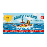 Amity Island 50th Annual Regatta poster with a woman on a raft and sun. Celebrate 50 years of Jaws with the Amity Island Beach Towel! Soft, absorbent, and vibrant, it's perfect for beach days or poolside relaxation.